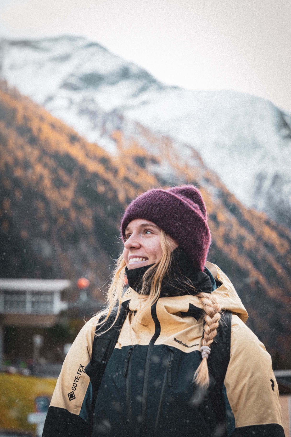 SnowCert participant smiling in front of an alpine peak